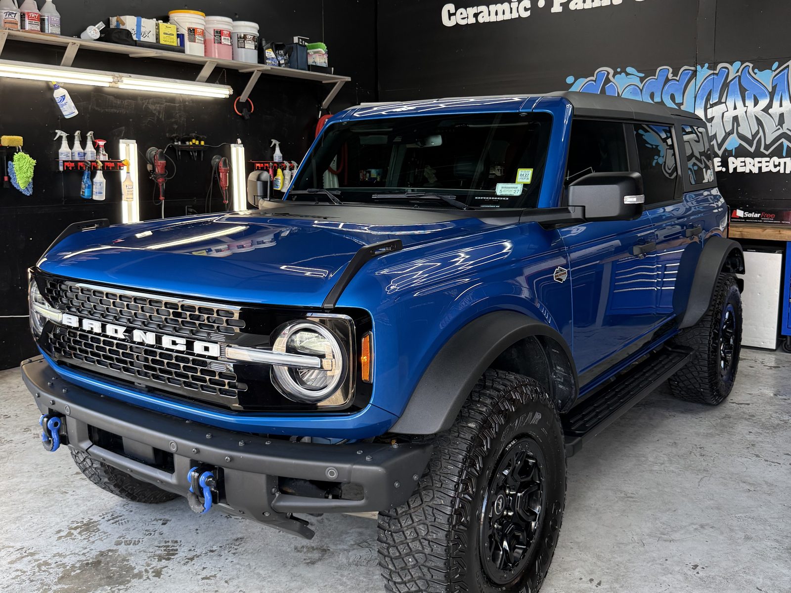 Blue Ford Bronco under hex lights