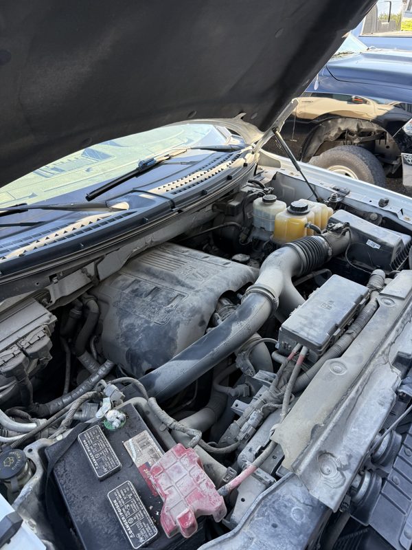 Dusty engine bay before cleaning