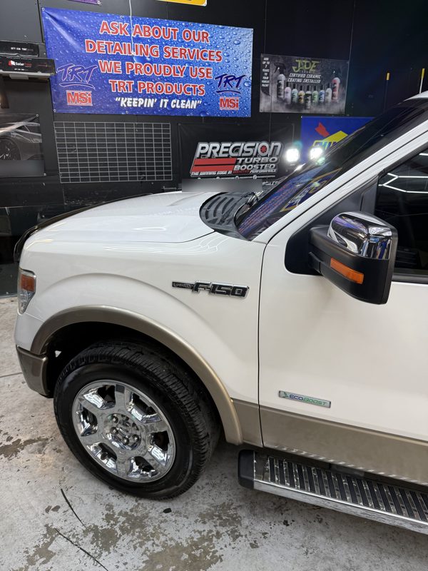 Clean chrome wheel and tire on a detailed F-150