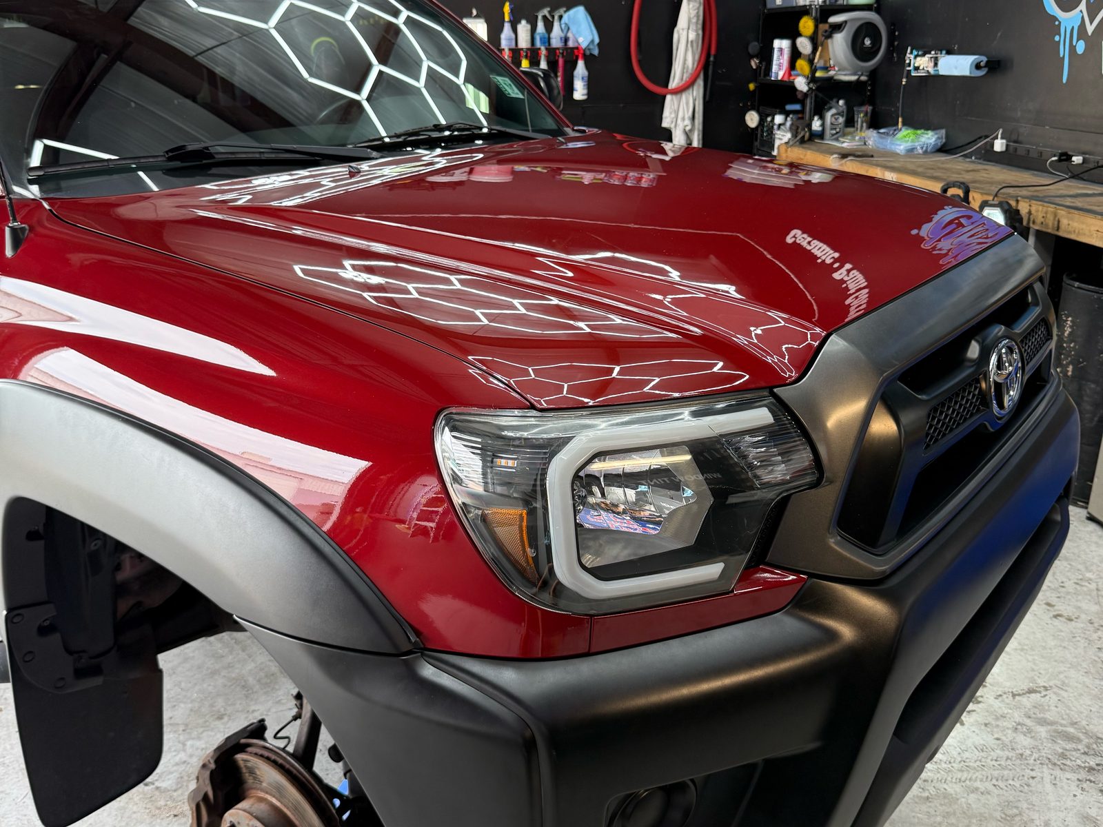 Red Tacoma hood reflecting hex lights