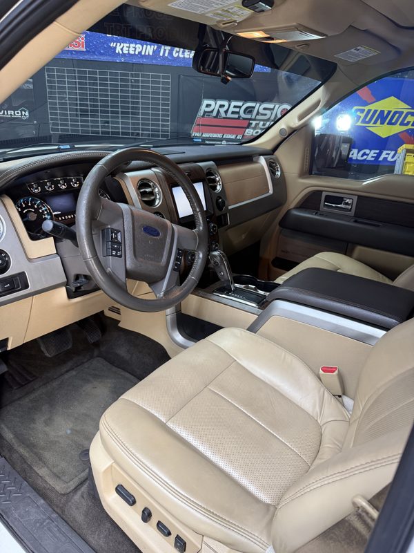 Clean tan leather front seats and dash after an interior detail