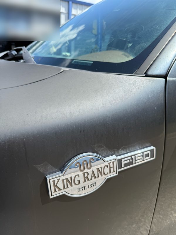 King Ranch fender badge on dull, oxidized paint