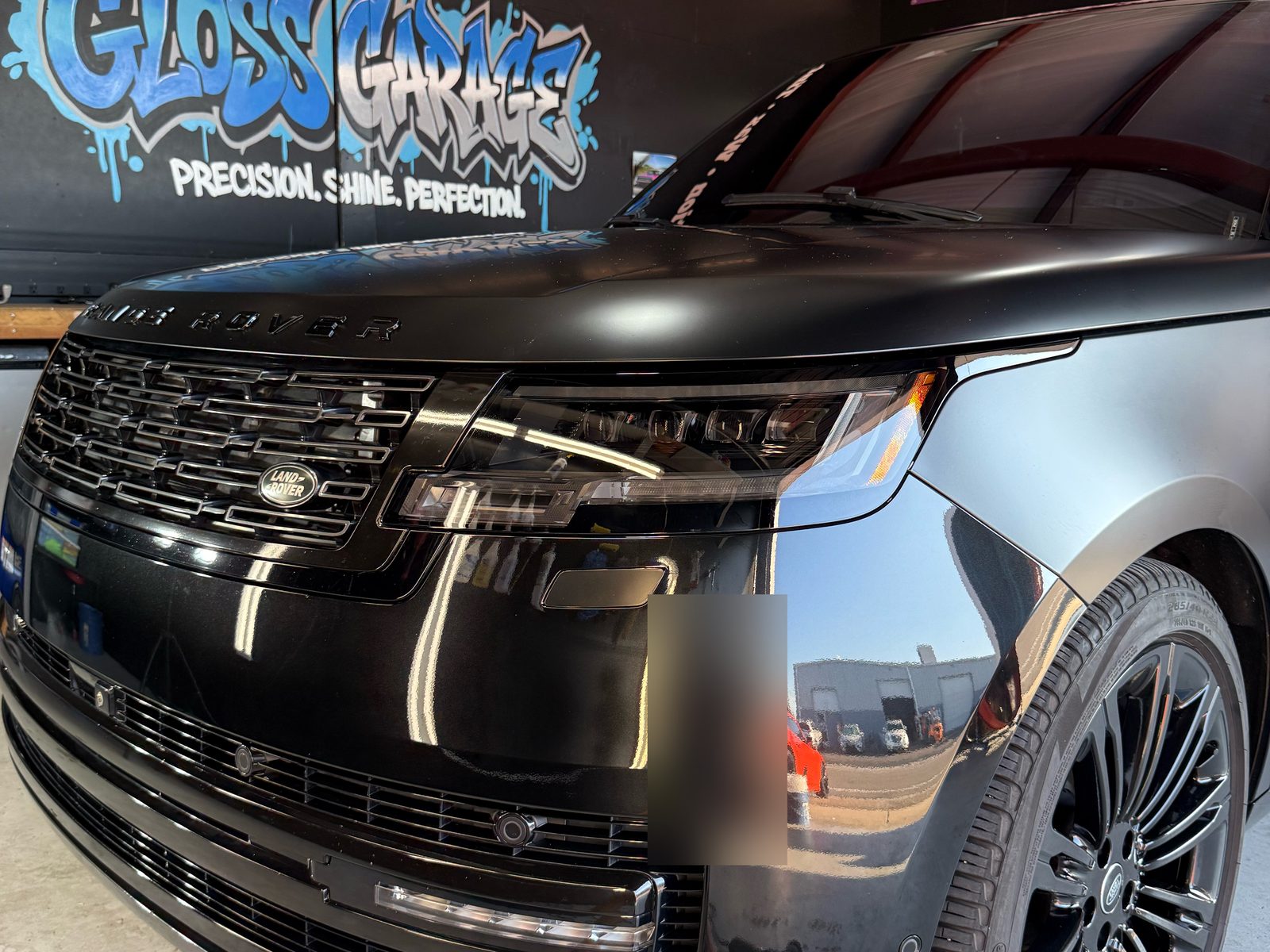 Range Rover front end under the Gloss Garage mural after PPF