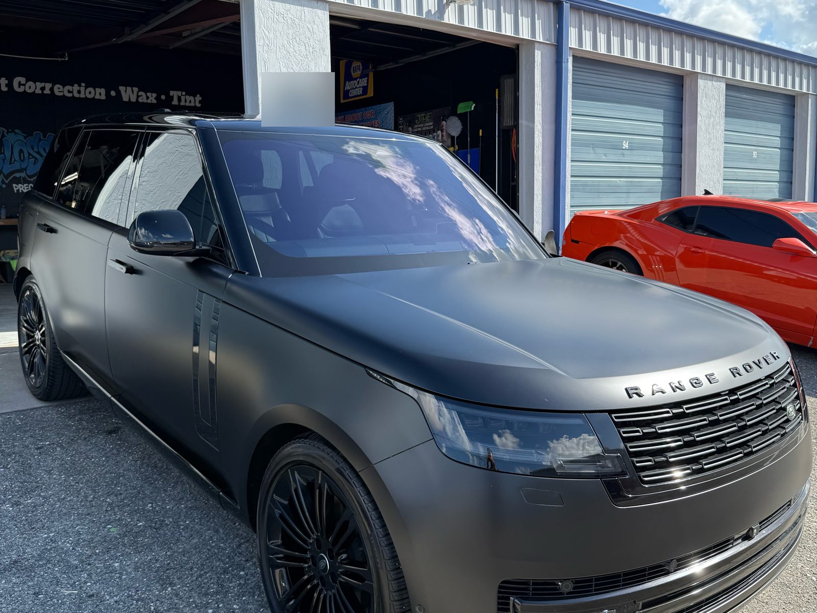 Satin black Range Rover with front-end PPF outside the Gloss Garage shop