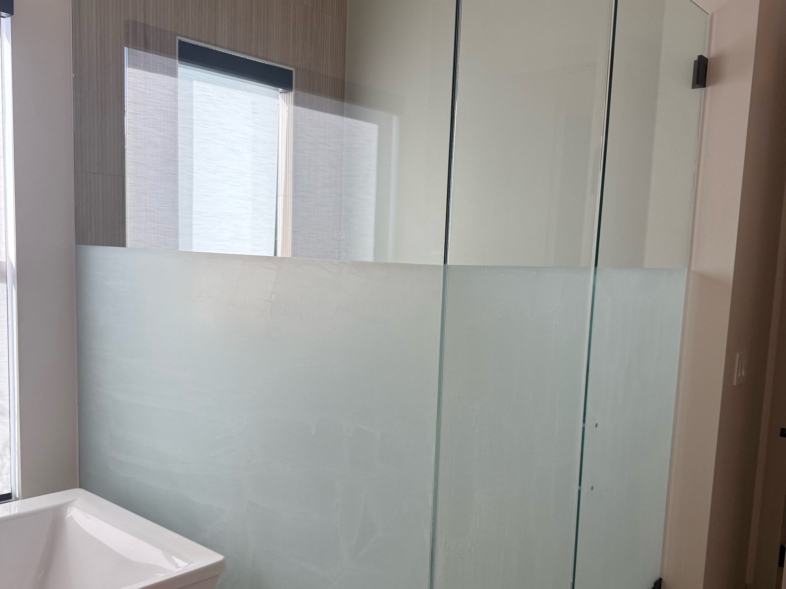 Shower glass with frosted privacy film