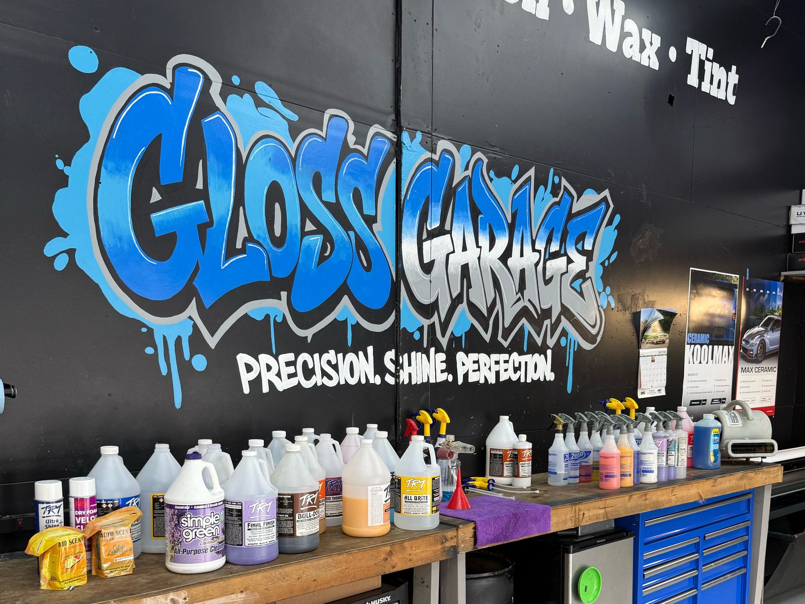 Bench of professional detailing products and a blue tool chest