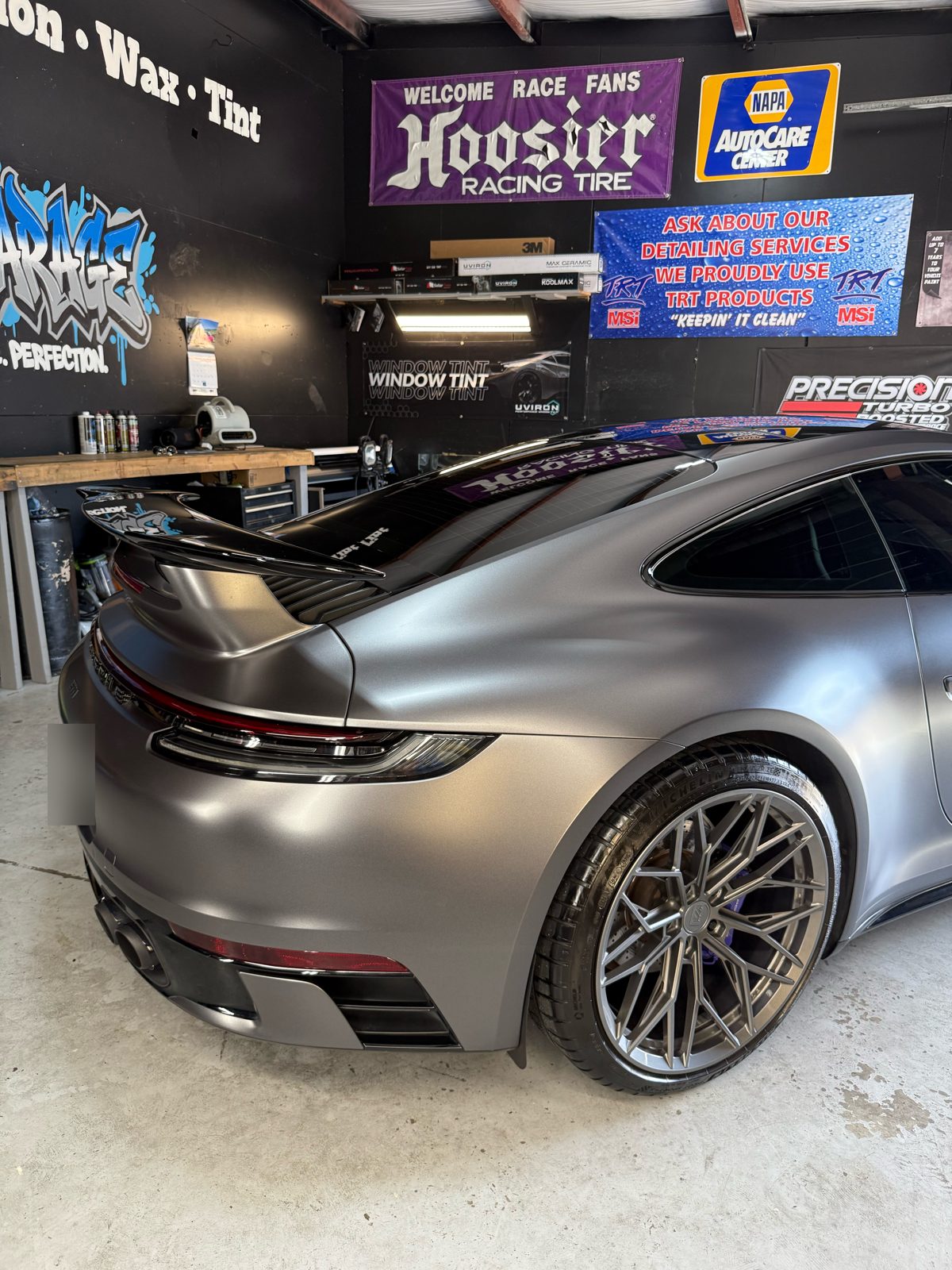 Porsche 911 in satin gray wrap in the Gloss Garage bay