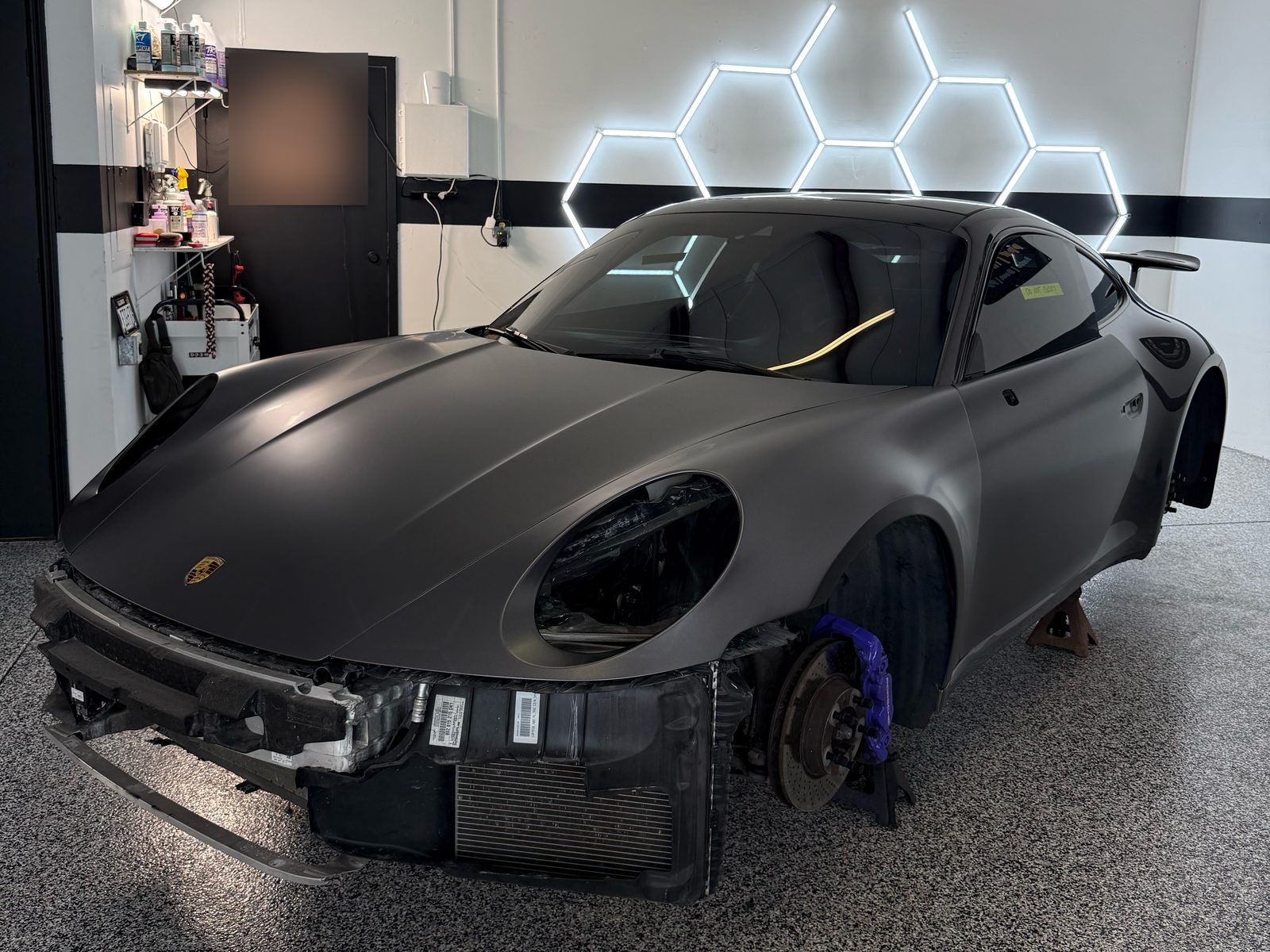Porsche 911 with the front bumper removed before wrapping